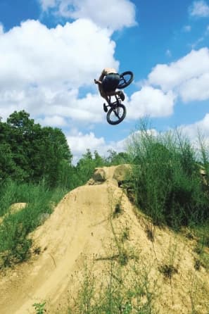 BMX rider extending a tabletop during an inverted aerial