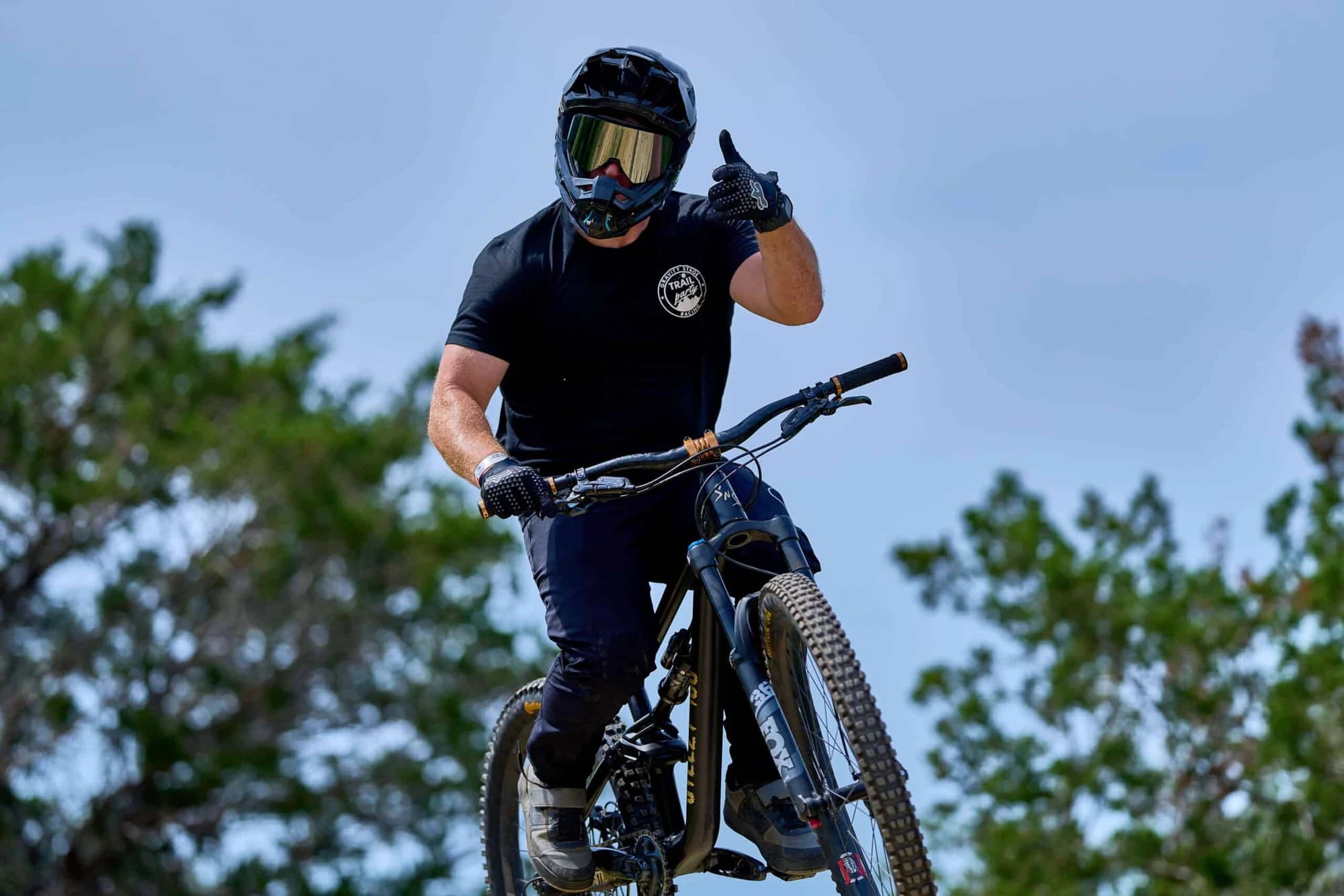 Mountain-bike rider in a full-face helmet with a downhill bike